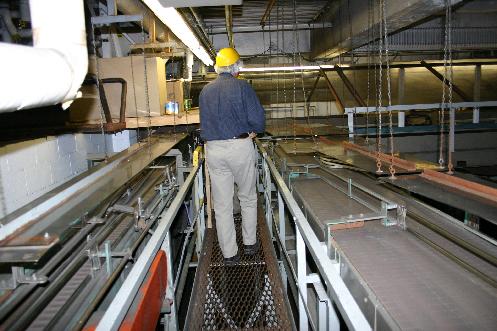 Part of the canning conveyor belt system. Empty cans make their way down the belt to the filling machines